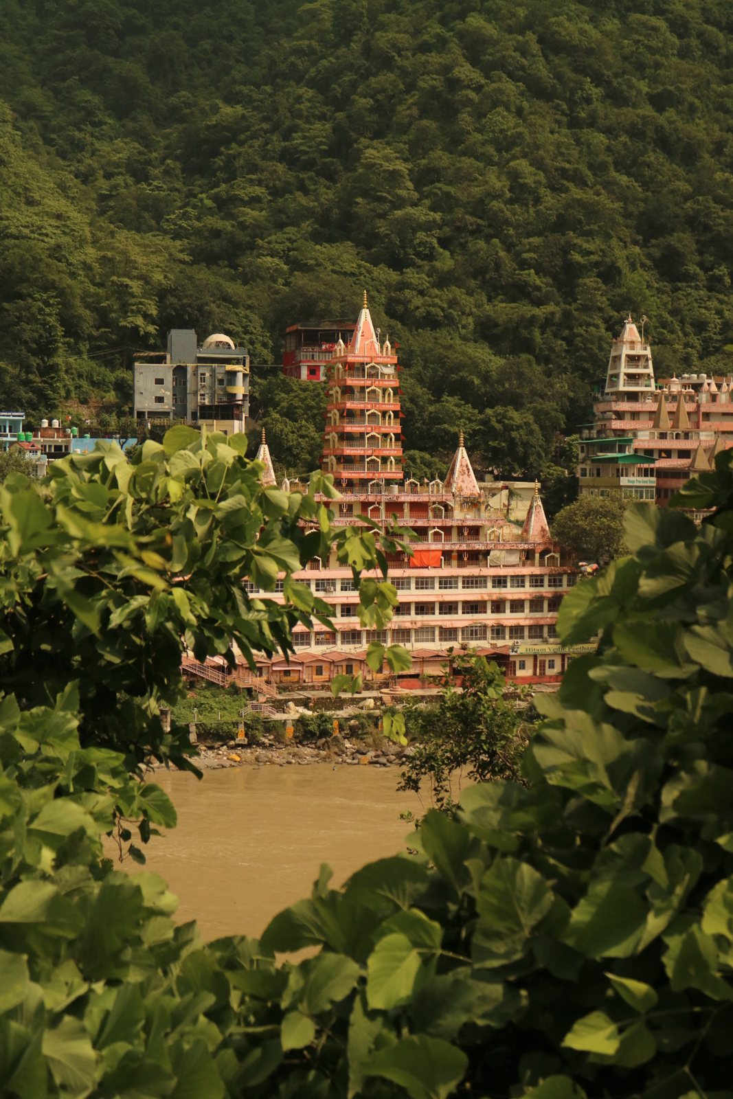 Pink temple towers above the Ganges in Rishikesh